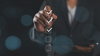 Businessman use pen to tick correct sign mark in checkbox for quality document control checklist...