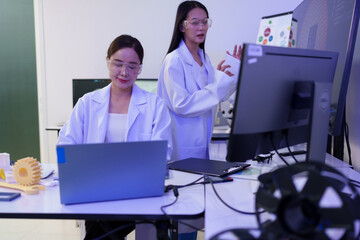 Researchers are working with a 3D printer to print clear, white plastic models using cutting-edge,...