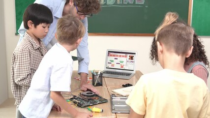 Cute energetic children working on electronic board while teacher using tablet analyze data. Group of diverse student fixing main board and learning about generated AI and programing system. Pedagogy. - Powered by Adobe