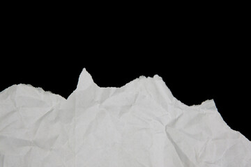White paper cut with torn edges isolated on black background.