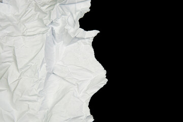 White paper cut with torn edges isolated on black background.