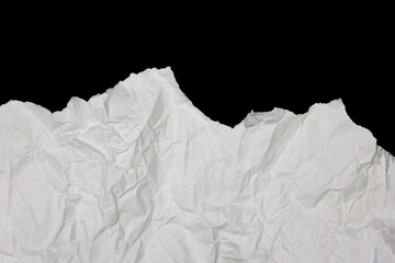 White paper cut with torn edges isolated on black background.
