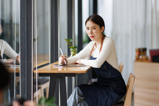 Startup successful small business owner sme beauty girl work in coffee shop restaurant. Portrait of asian tan woman barista cafe owner SME
