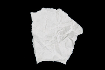 White paper cut with torn edges isolated on black background.
