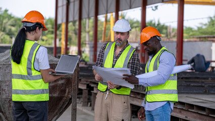 Engineers wearing helmets and vests at construction sit analyzing building plans work environment...