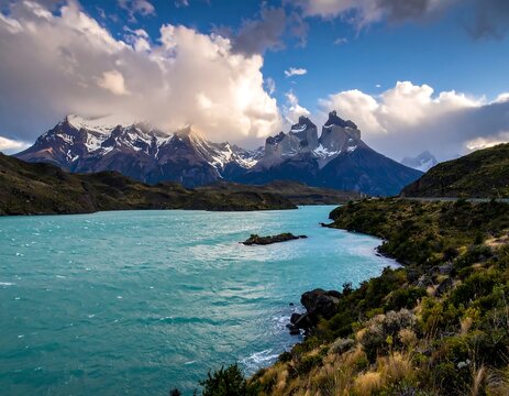Scenic mountain lake with vibrant turquoise waters under a cloudy sky