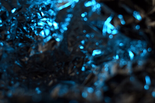Dark Blue Foil Texture with Metallic Shine. Abstract dark metallic blue texture with soft lighting and shiny reflective elements, ideal for modern backgrounds.