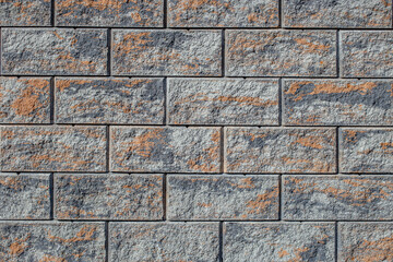 Stone patterned rectangular shape tiles aligned, exterior fence brick decoration in the sun light
