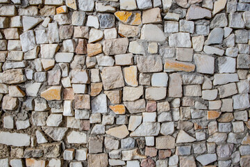 Square shaped granite cubes arranged randomly as a wall decoration, abstract patterned close up texture