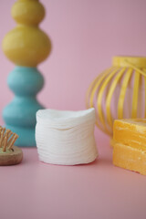cotton pads on a pink background with vibrant colors
