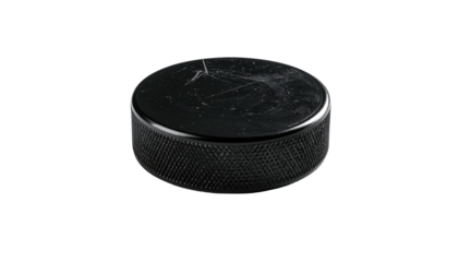 Circular black rubber disc with textured sides, scratches, and reflective top against a pure black background