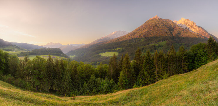 Meadow with road and bench during sunset in Berchtesgaden National Park