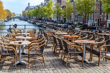 Outdoor dining area along scenic canal in Amsterdam