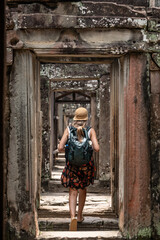 Woman exploring ancient temple ruins in southeast asia