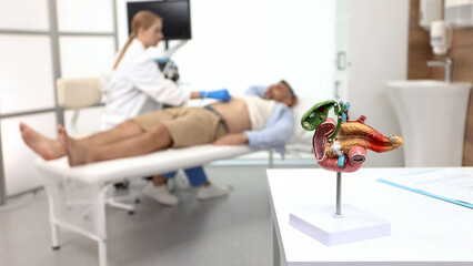 Obraz premium Abdominal ultrasound with ultrasound machine for male patient, close-up. Pancreas health