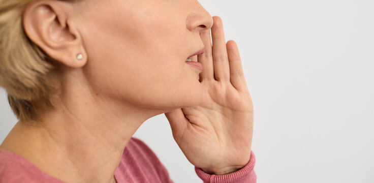 Woman calls the interlocutor by putting her hand to her mouth to amplify the sound. Social problem of deafness in people