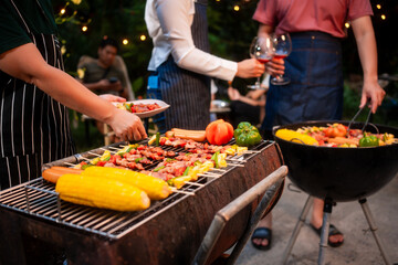 An Asian woman with friends grilling BBQ skewers, corn, and sausages outdoors. They toast with wine amid glowing string lights, creating a joyful and warm evening barbecue atmosphere