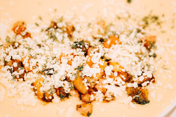 Delicious dish topped with herbs and cheese prepared in a warm kitchen