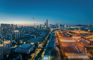 Aerial view of modern city's central business district skyline illuminated at dusk in Shenzhen.