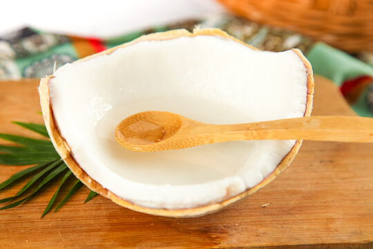 Fresh Coconut Milk in Natural Shell with Wooden Spoon - Tropical Kitchen Setting