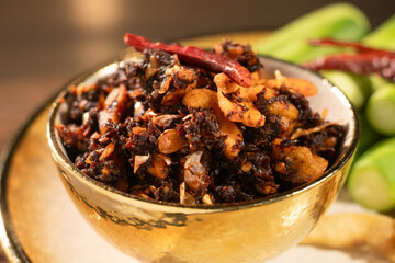 Pork Crackling Chili Paste (Nam Phrik kak Moo): Crispy, spicy, and savory. This Thai relish features crunchy cracklings, chili, and herbs. Served with fresh cucumber. A perfect crunch with hot rice.