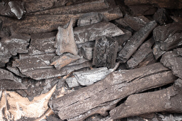 Charcoal, created by slowly burning wood.