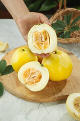 Fresh Yellow Melon Cut in Half Showing Sweet Interior on Wooden Board