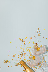 Party New Year with champagne glasses and bottle with golden confetti stars. Christmas, birthday or...