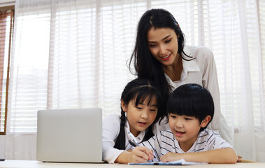 Happiness Asia kid girl and mom smile portrait looking smart phone for learning at home.