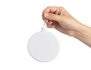Hand holding the blank smooth round ceramic bauble ornament with glossy finish, isolated on transparent background, PNG