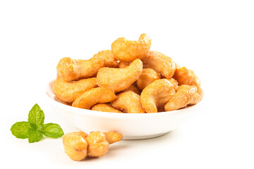 Crispy Roasted Cashew Nuts in Bowl with Mint Garnish on White Background