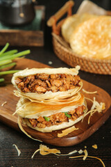 Chinese Meat Bun with Crispy Filling - Traditional Asian Breakfast Food on Wooden Plate