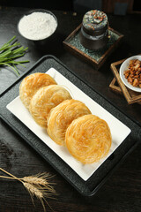 Traditional Chinese Layered Pastries with Ingredients on Rustic Wooden Table