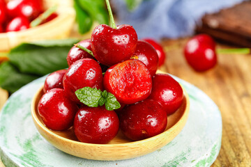 Fresh Red Cherries with Water Droplets in Wooden Bowl on Rustic Table