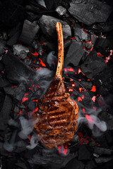 Juicy Prime Tomahawk steak on the grill, close-up. Black Angus steak. On charcoal. Top view.