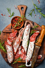 fuet sausage slicing on a wooden cutting board. Sliced ​​spanish sausage fuet. Close up.