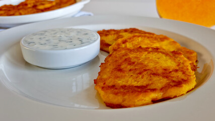 close-up of latkes with sour cream