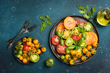 A plate with vegetarian tomato salad. Keto diet, healthy food. Fresh salad bowl. Top view.