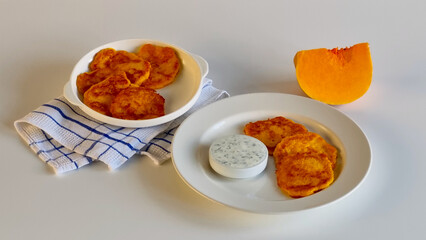 Latkes with sour cream and a slice of pumpkin