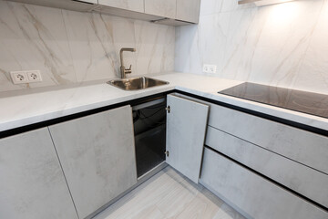 Brand new fitted kitchen with white cabinet and fully marble tiled walls