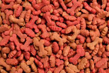 Close up photo. Dry dog ​​food in the form of bones, texture background of pet food.