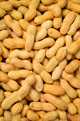Background of nuts. Unshelled peanuts close-up. Nut texture.