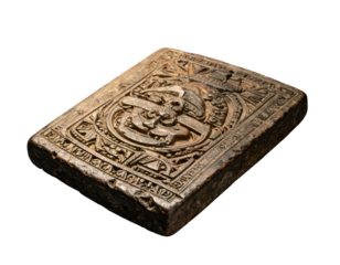 Old, rectangular, carved block; likely stone or clay, with relief design and aged texture