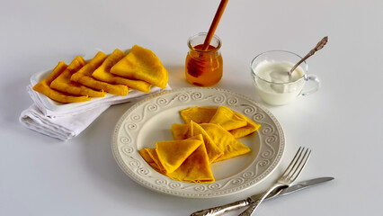 A top view of crepes drizzled with honey