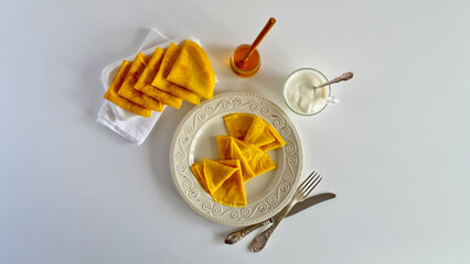 A top view of crepes drizzled with honey