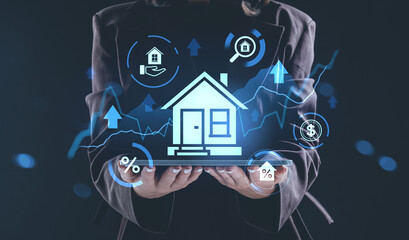 Real estate businesswoman presenting futuristic house and finance hologram interface concept on digital tablet with growth chart and currency signs.