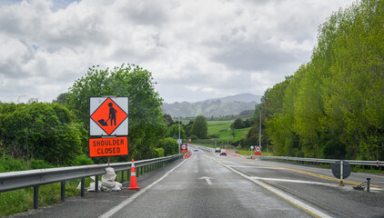 Works Ahead sign on motorway. 80km/h temporary speed limit road sign ahead. North Island. New Zealand.