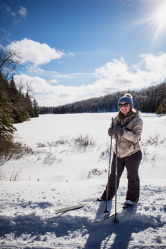 Female cross country skier on a sunny winter day in New England