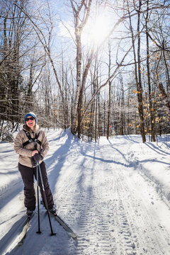 Female cross country skier enjoying snowmobile trails in NH