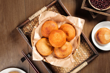 Traditional Asian Fried Glutinous Rice Cakes with Red Bean Paste in Bamboo Basket